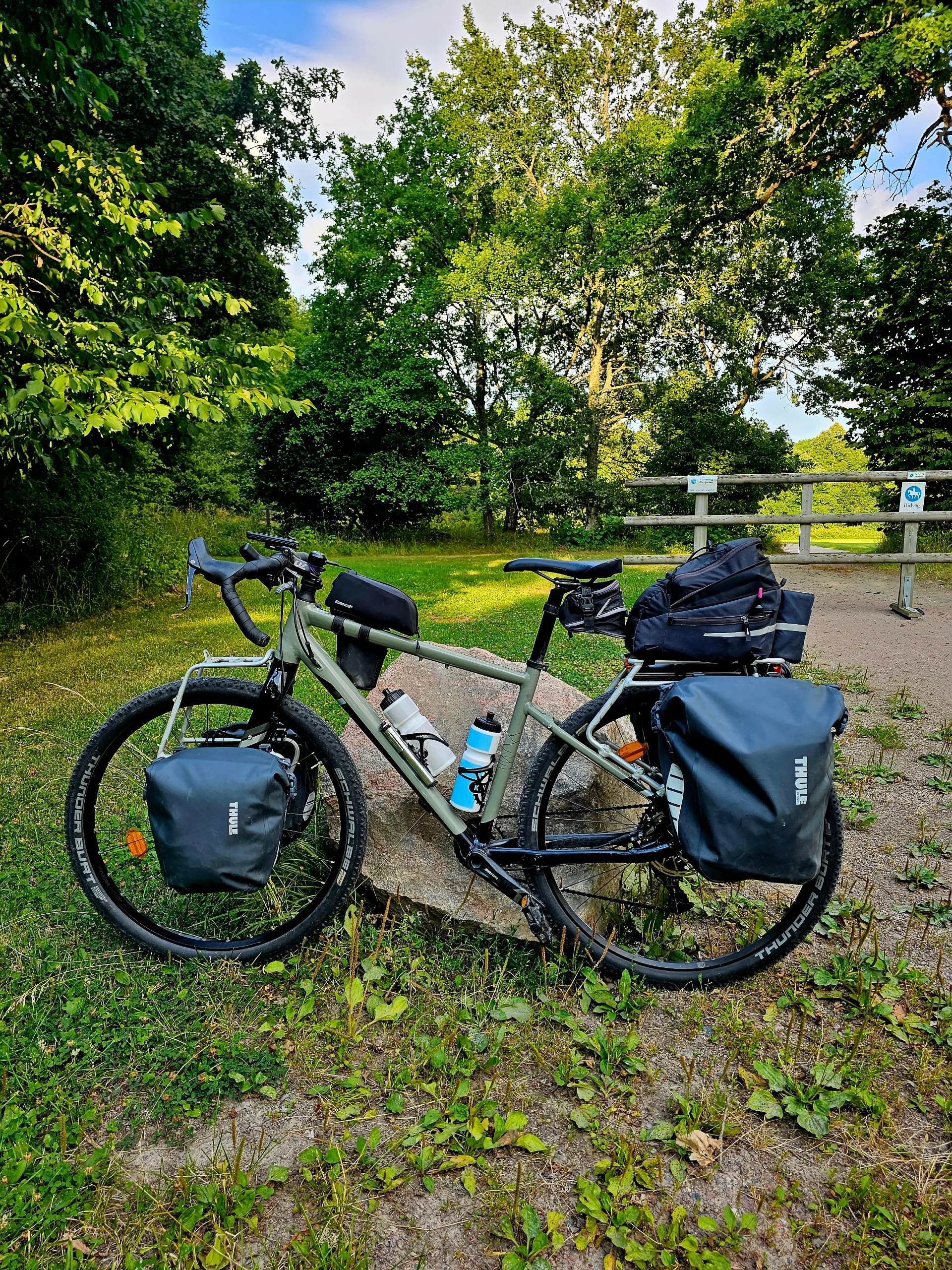 Touring bike leaning against a stone